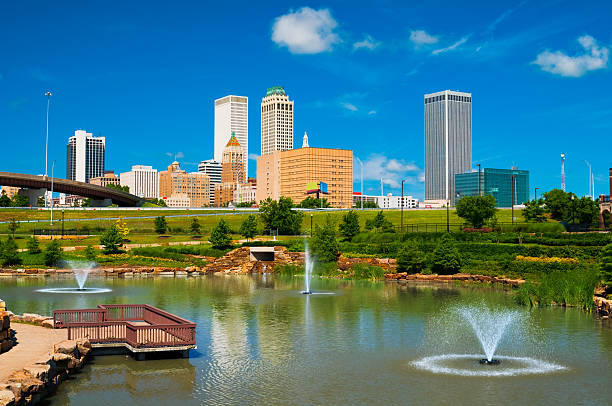 "Tulsa Skyline With A Park, Pond, And Fountains In The Foreground."